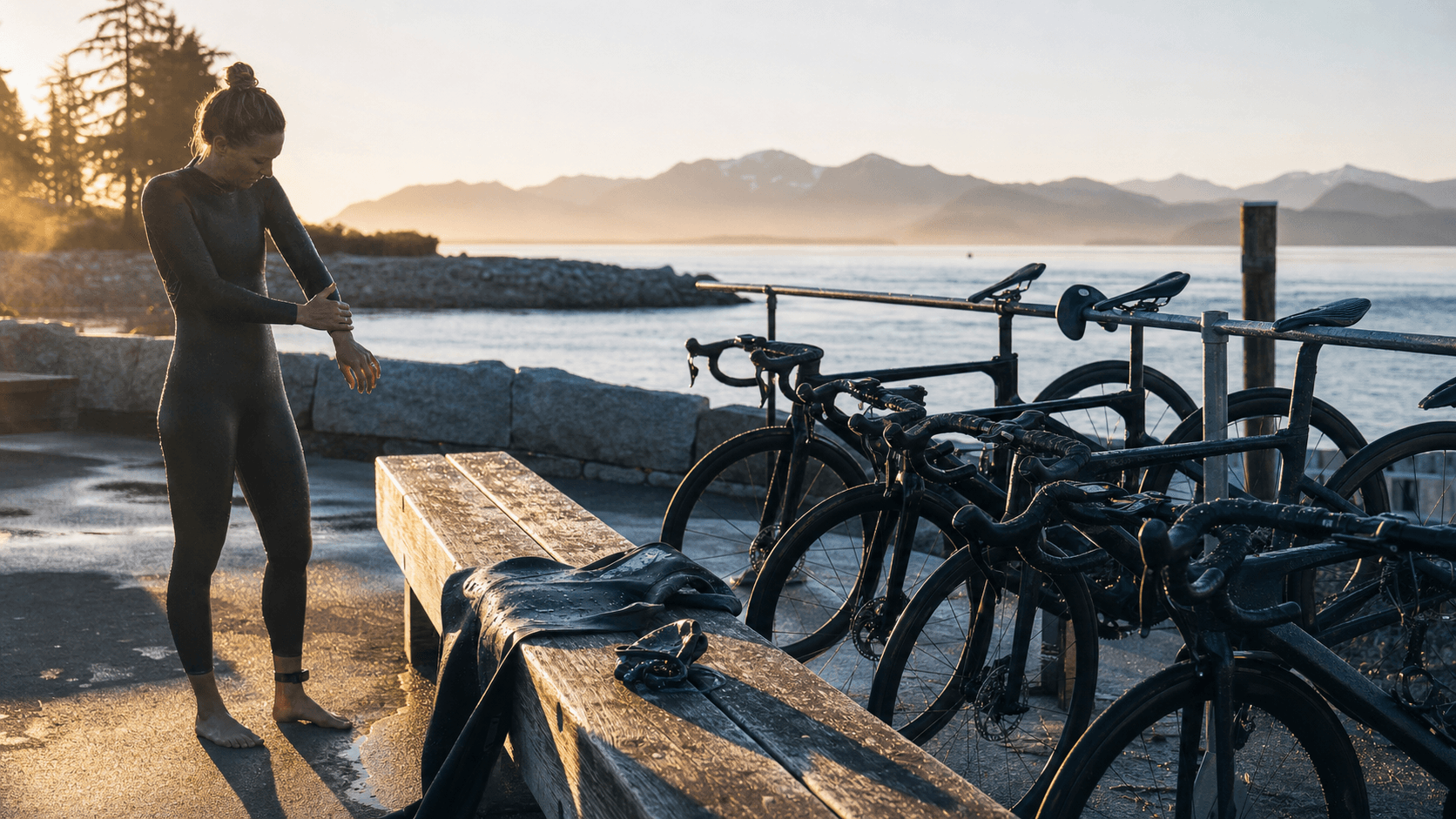 Pacific Northwest triathlon venue at dawn with calm ocean and unbranded transition bikes